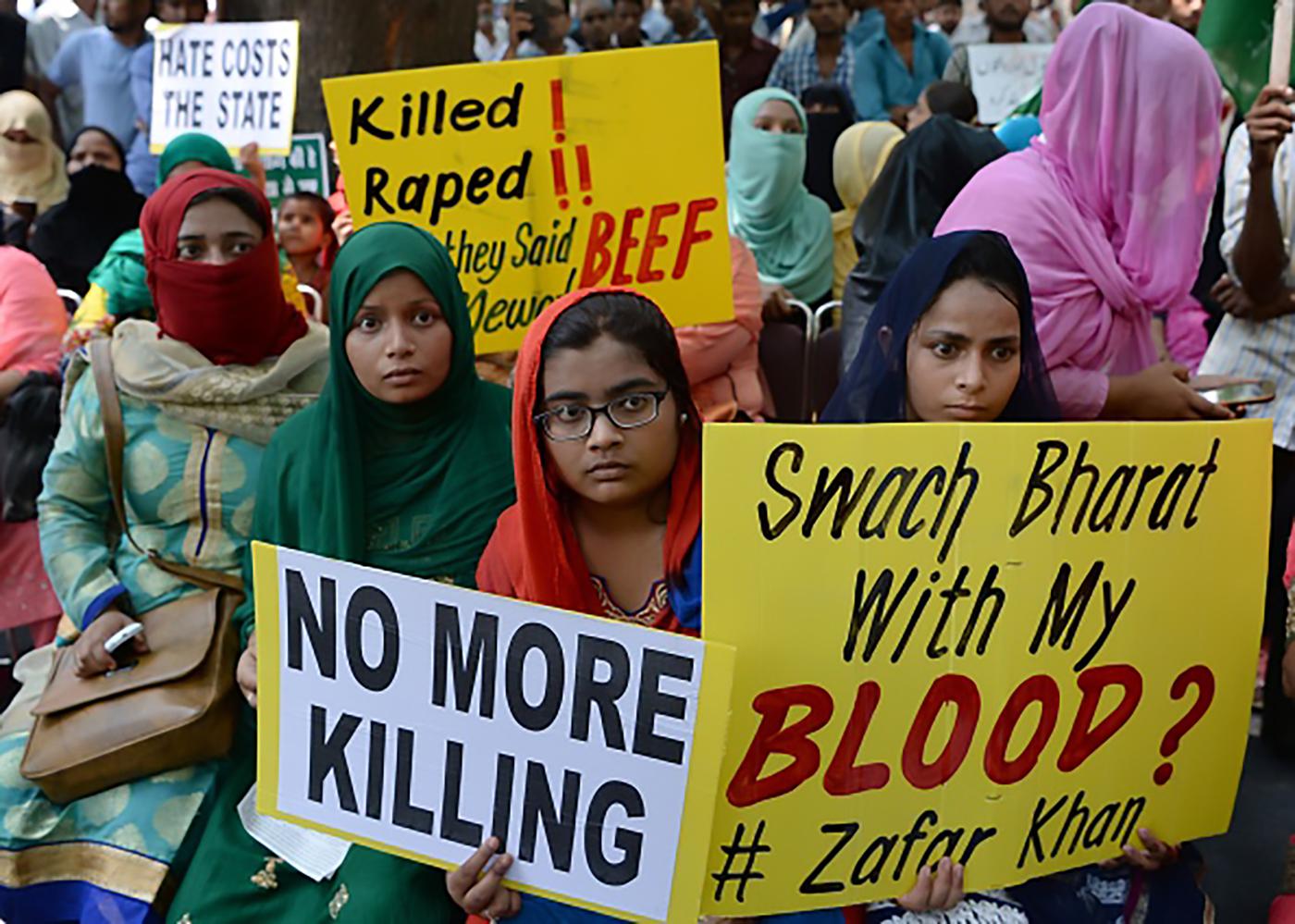 Indian demonstrators hold placards as they take part in a rally in New Delhi on July 18, 2017, in protest over a spate of assaults against Muslims and low-caste Dalits by Hindu vigilantes in India.