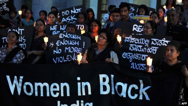 Indian activists belonging to various rights organizations hold placards and candles while they stage a demonstration in Bangalore condemning the recent gang-rape case.