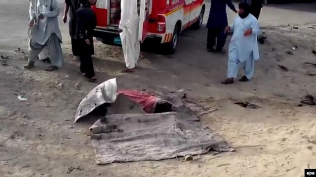 A dead body covered on the ground at the alleged scene of a drone strike that killed the Afghan Taliban's supreme leader, Mullah Akhtar Mansur, in the Ahmad Wal area of Balochistan on May 21.