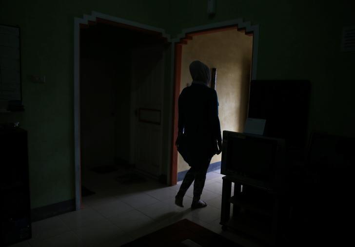 A transgender person walks out of her office in Banda Aceh, Indonesia on December 25, 2014.