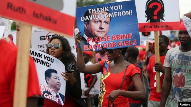 Demonstrators carry signs as they attend a protest in Lagos on May 9 demanding the release of the more than 250 school girls abducted by militants in the remote village of Chibok.