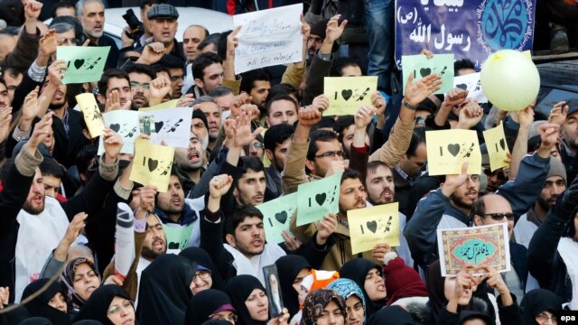 Iranians hold signs reading 'I love Muhammad' during a protest against the printing of satirical sketches of the Prophet Muhammad by French satirical weekly Charlie Hebdo outside the French Embassy in Tehran on January 19.