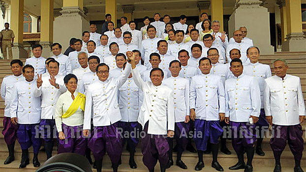 Cambodia's 55 National Assembly lawmakers stand outside the Royal Palace before their swearing-in ceremony in the capital Phnom Penh, Aug. 5, 2014.