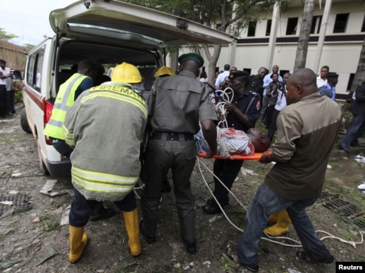 A victim of the blast at the UN offices is loaded into an ambulance in Abuja.