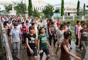 Cambodian workers leave after their shift at a garment factory in Phnom Penh on July 5, 2008. AFP