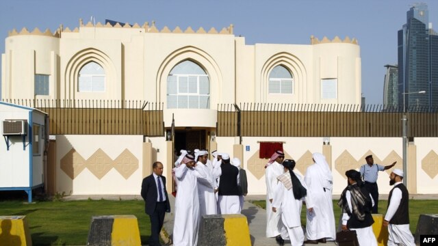 Guests arrive for the opening ceremony of the new Taliban political office in Doha on June 18.