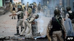 Indian security forces clear road blockades following clashes with Kashmiri protestors in Srinagar, Kashmir, in August.