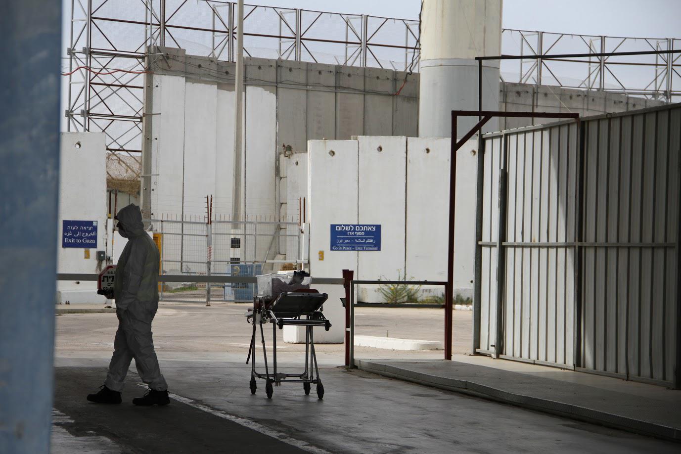 A staff member at the Erez Crossing between Israel and Gaza waits during the transfer of a 6-day-old baby from Gaza to a hospital in the city of Nablus in the occupied West Bank for medical treatment. Israeli authorities approved permits for medical appoi