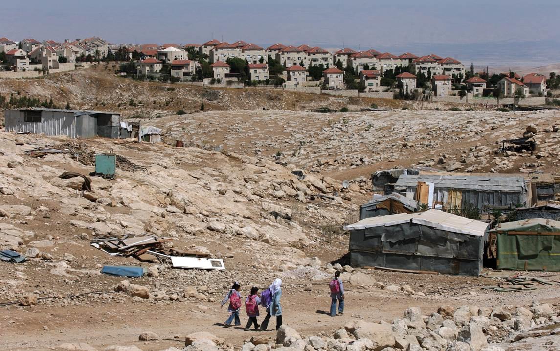 Palestinian Bedouin school children walk towards their tents on September 15, 2010 at their Bedouin camp outside the Israeli West Bank settlement of Ma'ale Adumin. Israel does not recognize the Bedouins' property claims and has demolished homes and schools in the area.