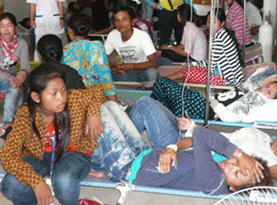 Some of the Cambodian workers affected by the mass fainting incident at Nanguo Garment Co. Ltd. resting in hospital in Sihanoukville, Feb. 13, 2012.