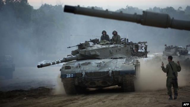 An Israeli tank maneuvers at an army deployment area near the Israel-Gaza Strip border on November 22.