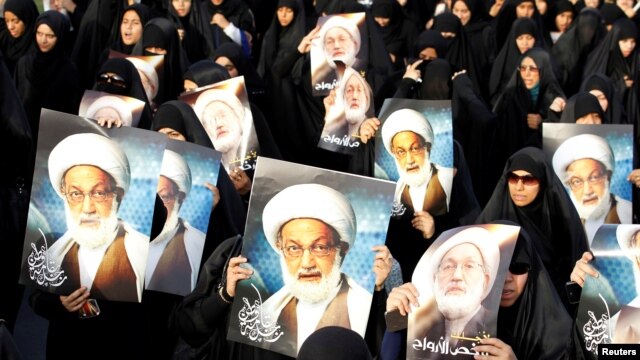 Bahraini protesters hold up posters of Shi'ite cleric Ayatollah Isa Qassem during an antigovernment demonstration in 2013.