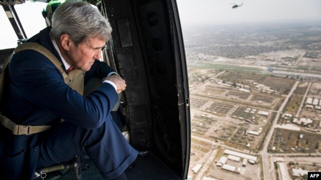 U.S. Secretary of State John Kerry looks out over Baghdad from a helicopter during a visit to the Iraqi capital on September 10.