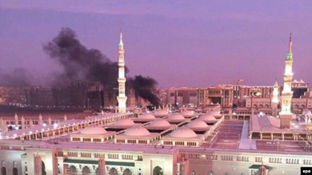 Smoke rises behind the Prophet Muhammad Mosque in Medina after a suicide attack on July 4.