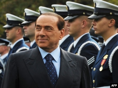 Italian Prime Minister Silvio Berlusconi inspects the honor guard during a welcome ceremony at the White House in October 2008.
