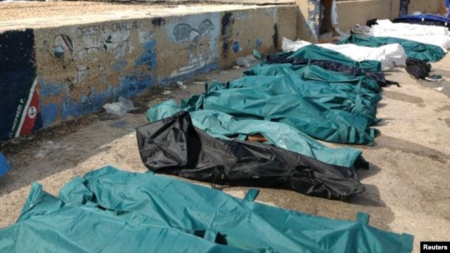 Body bags containing African migrants, who drowned trying to reach Italian shores