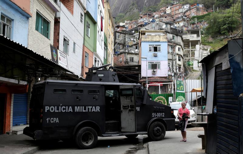 Police officers patrol the Rocinha slum after violent clashes between drug gangs, in Rio de Janeiro, Brazil September 29, 2017. The banner reads: 