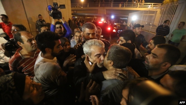 Nine Lebanese hostages are greeted by cheering crowds in Beirut.