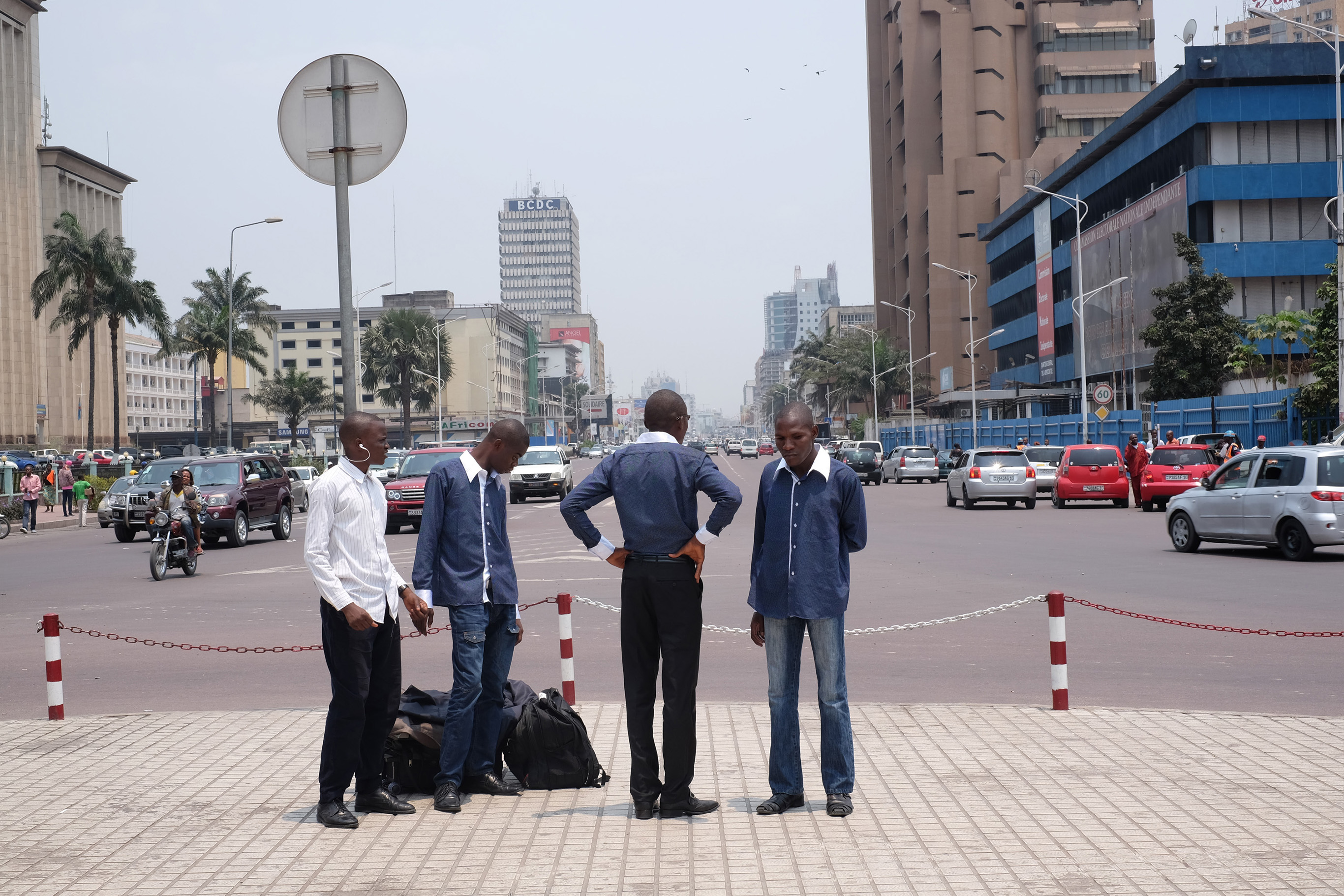 Four men stand by the main road in Kinshasa, DRC