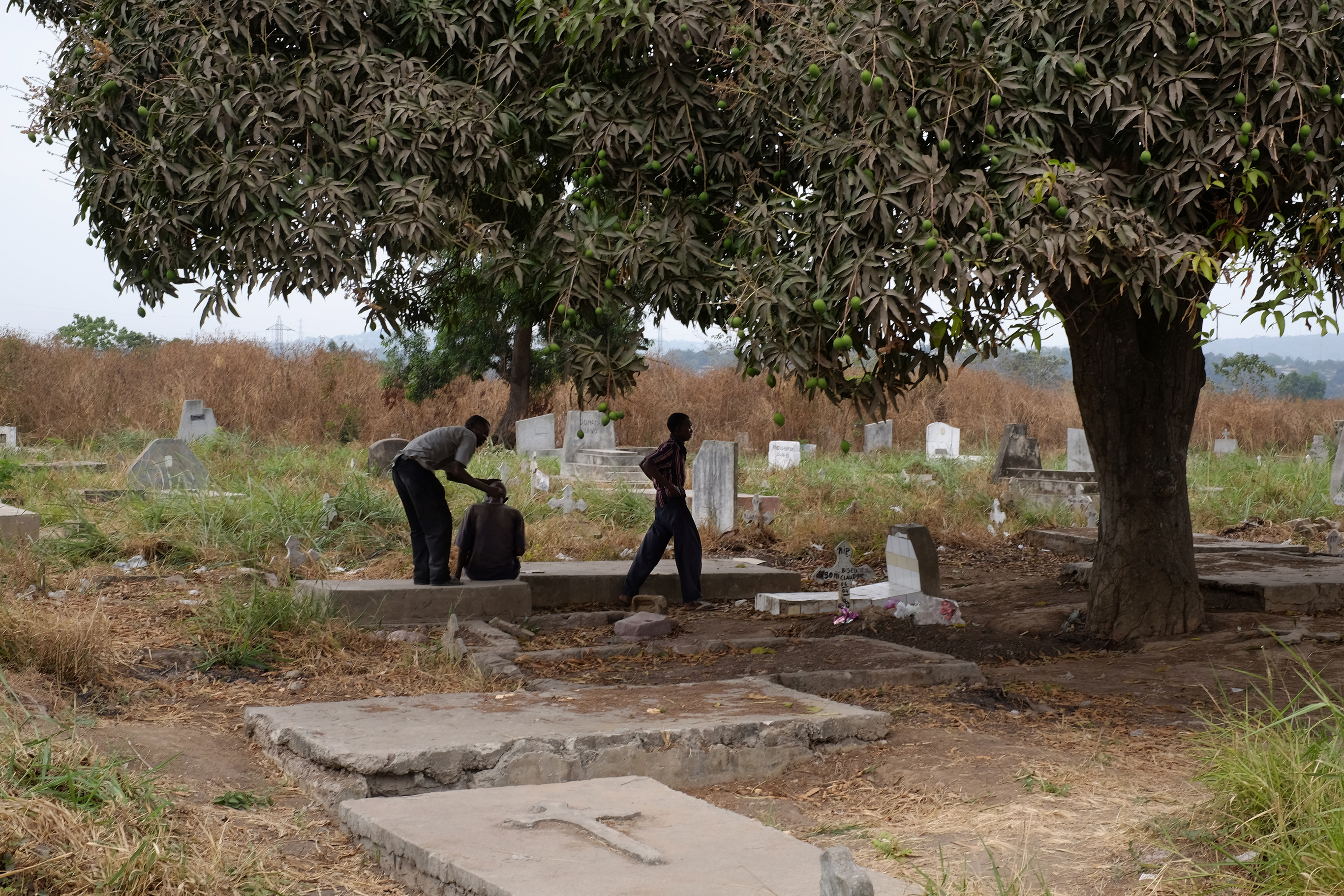 People walking in a graveyard, DRC