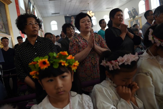 Chinese Catholics attend a mass to mark the ascension of Jesus at a Catholic church in Tianjin, in northern China on May 24, 2015.