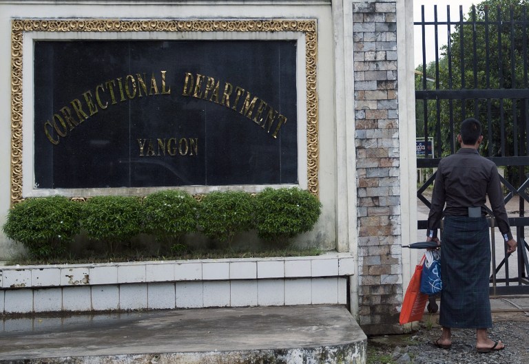 A man looks on near the gates of Insein Prison in Yangon, July 23, 2013.