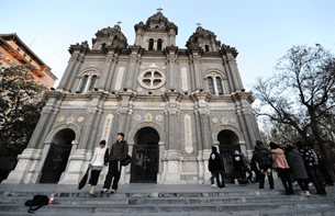 Youngsters stand in front of a Catholic cathedral in Beijing, Nov. 21, 2010.