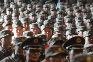 Young military recruits gather for a ceremony in Beijing prior to their departure for Tibet, Nov. 20, 2011. AFP