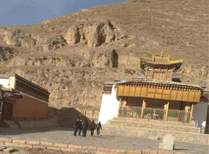 Chinese officials inspect the site of the self-immolation near the Bora monastery.