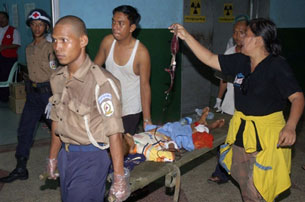 This handout picture released by Myanmar News Agency on April 16, 2010, shows medical staff using a stretcher to carry an injured child into a hospital in Rangoon, April 15, 2010.