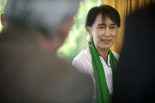 Aung San Suu Kyi speaks with Swiss apprentices on the train between Geneva and Bern on her first trip to Europe in nearly quarter of a century.