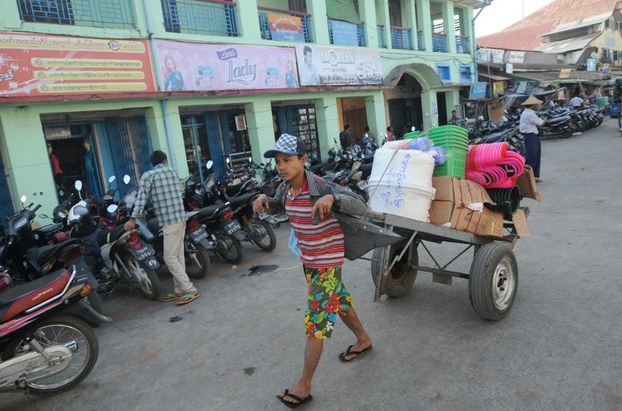 An ethnic Rakhine worker pulls a cart near a market place in Sittwe, Rakhine state, Feb. 27, 2014.