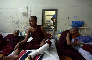 Monks injured in the crackdown on the copper mine protests rest at a hospital in Mandalay on Dec. 3, 2012.