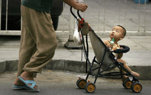 A baby looks up at his mother on a street in Beijing, Aug. 25, 2007.
