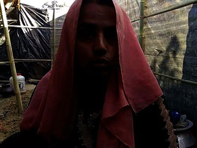 A Rohingya Muslim woman discusses a sexual assault by Myanmar security forces during a crackdown in northern Rakhine state, at Kutupalong refugee camp in Cox's Bazar, southeastern Bangladesh, Jan. 14, 2017. This photograph has been darkened to protect her identity.