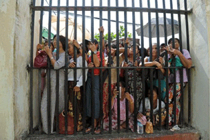 Family members of prisoners wait for their release outside the Insein central prison in Rangoon, Oct. 12, 2011.
