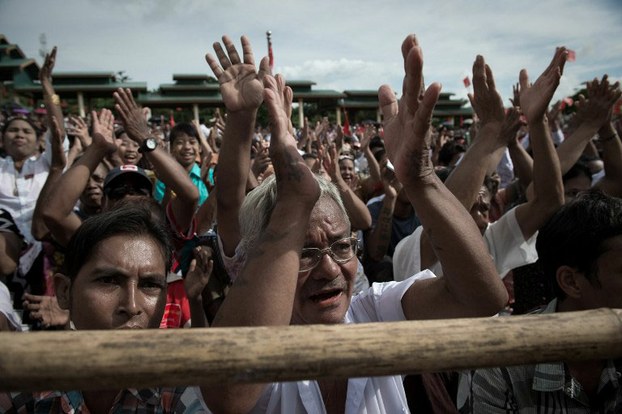 Supporters of National League for Democracy chairperson Aung San Suu Kyi (not pictured) shout and applaud at a rally on the outskirts of Yangon, August 21, 2015.