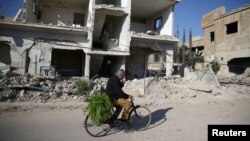 Damaged buildings in the rebel-held besieged city of Douma, in the eastern Damascus suburb of Ghouta, on December 30.