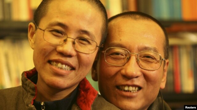 Chinese dissident Liu Xiaobo (right) and his wife Liu Xia pose in a photo released by his family.