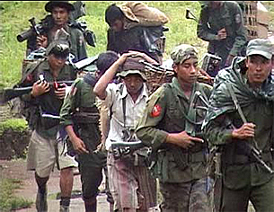 Undated photo of Burmese soldiers using forced porters in operations areas.