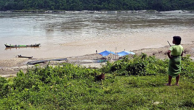 A Myanmar woman stands on the bank of the Irrawaddy River in the country's northernmost Kachin state in a file photo.