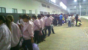 An undated photo shows workers at the Foxconn plant in Zhengzhou.