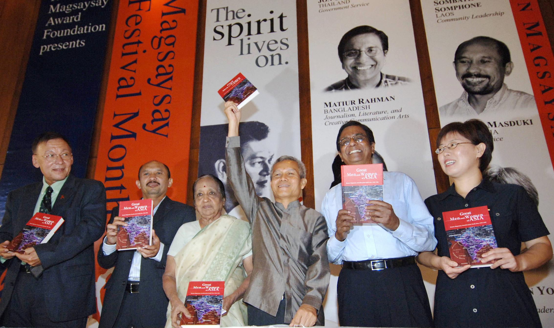 Sombath Somphone (third from right) and other recipients of the 2005 Ramon Magsaysay Award link arms during a ceremony in Manila, in a file photo.