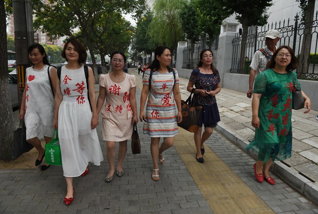 Wives of Chinese human rights lawyers detained in a 2015 crackdown wearing the names of their husbands after filing complaints at the Supreme People's Procuratorate in Beijing, July 4, 2016.
