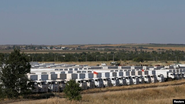 A Russian convoy of trucks carrying humanitarian aid for Ukraine waits at a camp near Kamensk-Shakhtinsky, in Russia's Rostov region.