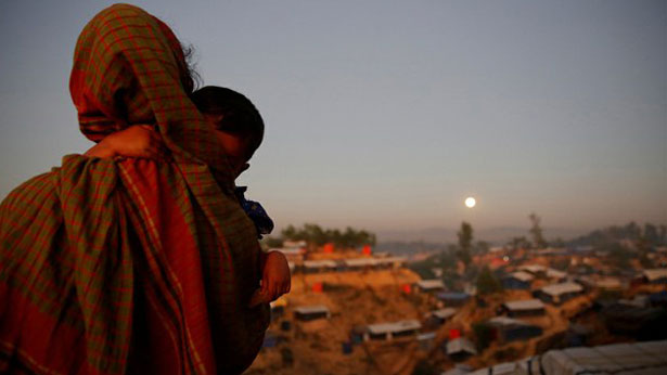 A Rohingya woman holds her child at the Balukhali refugee camp near Cox's Bazar, Bangladesh, Dec. 3, 2017.