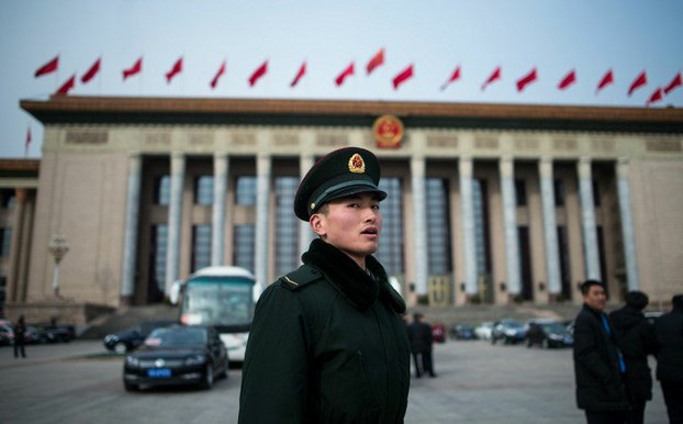 Security guards patrol outside the Great Hall of the People in Beijing during the second day of the National People's Congress, March 6, 2016.