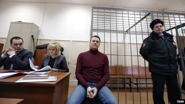 Russian opposition leader Aleksei Navalny (center) attends a court hearing in Moscow on February 28.