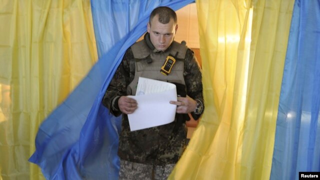 A Ukrainian serviceman after casting his vote in parliamentary elections at a polling station in Novoaidar near Luhansk on October 26.