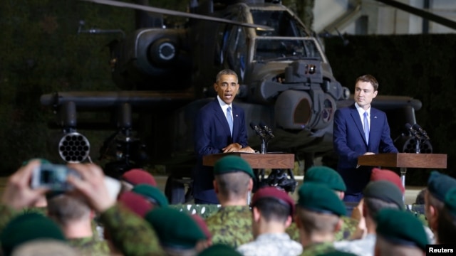 U.S. President Barack Obama (left) and Estonian Prime Minister Taavi Roivas speak to U.S. and Estonian troops at Tallinn Airport on September 3.